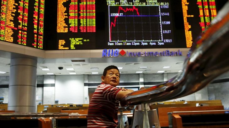 An investor monitors share market prices in Kuala Lumpur, Malaysia