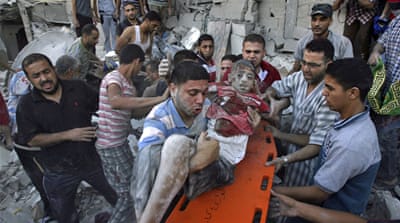 Palestinians evacuate a survivor of an Israeli air strike that hit a building in southern Gaza Strip in August 2014 [AP]