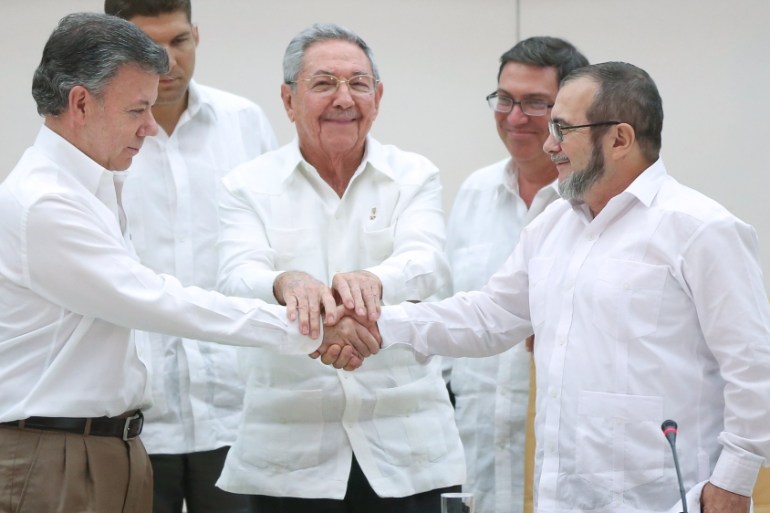 Cuba''s President Raul Castro (C) stands as Colombia''s President Juan Manuel Santos (L) and FARC rebel leader Rodrigo Londono, better known by the nom de guerre Timochenko, shake hands in Havana