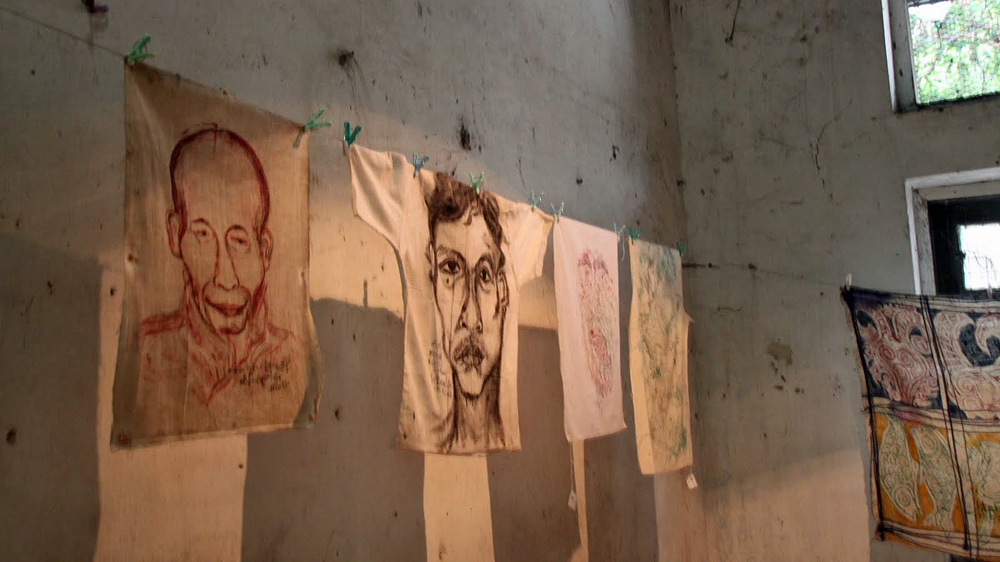 Prison clothes and sheets served as canvas for the artist while in prison [Mark Fenn/Al Jazeera]