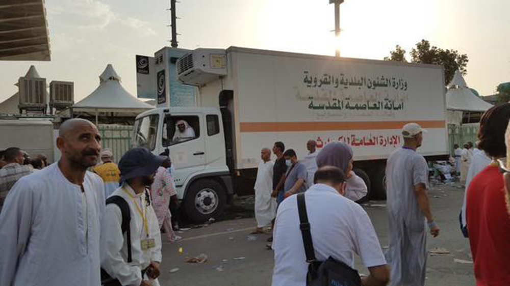 Trucks were being filled with the remains of hundreds of pilgrims who died in the stampede [Basma Atassi / Al Jazeera]