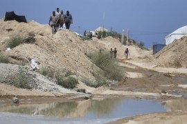 Palestinians inspect the damage beneath the Gaza-Egypt border, in Rafah in the southern Gaza Strip