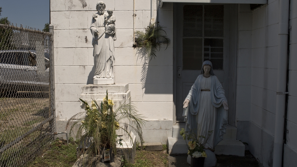 Religious figures stand outside Saint Augustine Church in the Faubourg Treme neighbourhood in New Orleans [Roopa Gogineni]