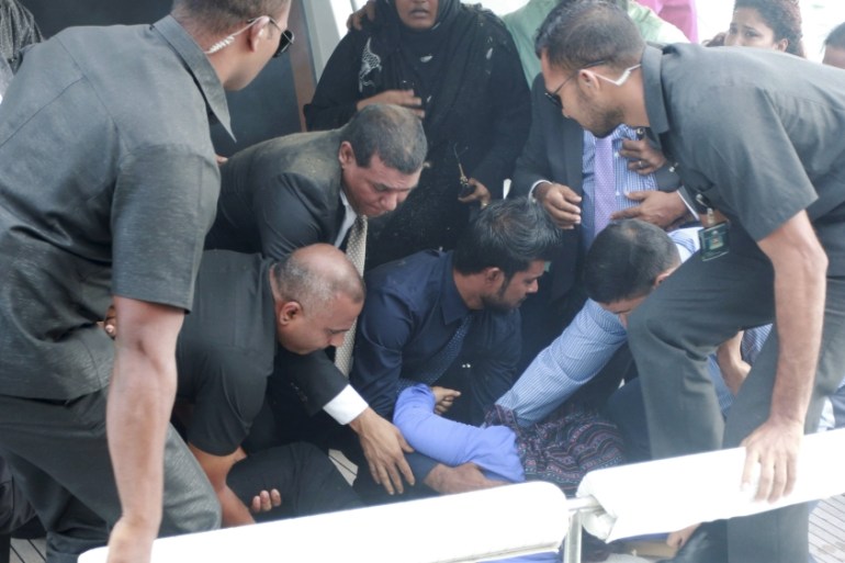 Officials carry an injured woman off the speed boat of Maldives President Abdulla Yameen after an explosion onboard, in Male, Maldives