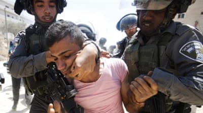 Israeli border police detain a Palestinian during a protest against the Israeli separation barrier, in the West Bank [AP] 