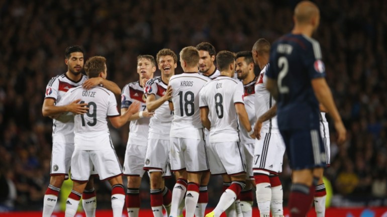 Thomas Muller celebrates with team mates after scoring the second goal for Germany