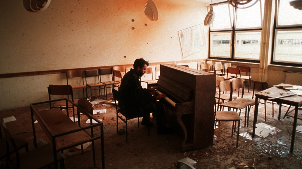 A Croat sniper plays Bach on a piano during a lull in the fighting. The soldier told me he had taught art in the same classroom from which he was now a sniper. This collision of art, culture and war was difficult for me to fathom. 1994 [Jack Picone] 