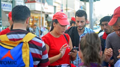 Vodafone vendors soliciting customers among the refugees [Simon Marks/Al Jazeera]