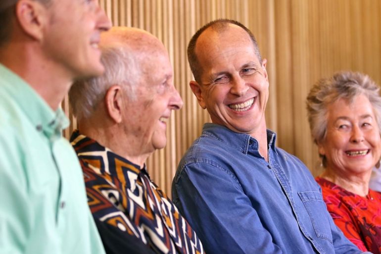 Australian journalist Peter Greste smiles as he sits next to his mother Lois and father Juris during media conference in Brisbane