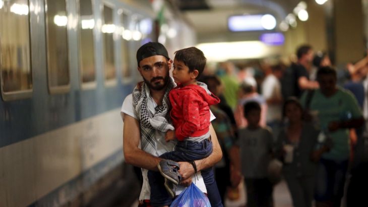 Travellers believed to be migrants leave a train coming from Hungary at the railway station in Vienna