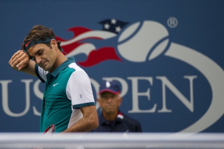 Federer of Switzerland wipes his brow during his match with Mayer of Argentina in their first round match at the U.S. Open Championships tennis tournament in New York