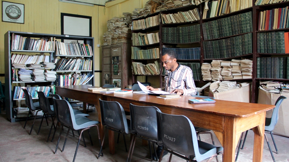 Librarian Olatunji Onalaja in the museum’s library [Femke van Zeijl/Al Jazeera]