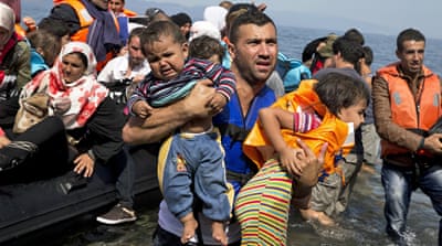 Syrian refugees arrive aboard a dinghy after crossing from Turkey to the island of Lesbos, Greece [AP] 