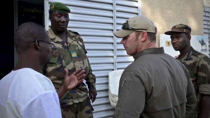 An unidentified U.S. Special Operations Forces team sergeant leader speaks with his counterpart from Niger, Sergeant Fougou Saley (2nd L), in Diffa, Niger
