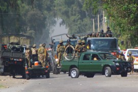 Pakistani army troops surround an air force base, Friday, Sept. 18, 2015 in Peshawar, Pak