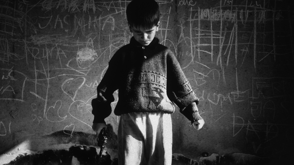 Rocky (his nickname) plays war games during the siege of Sarajevo. Like many children in the city during the war, he displayed signs of stress, aggression and erratic behaviour. 1994 [Jack Picone] 