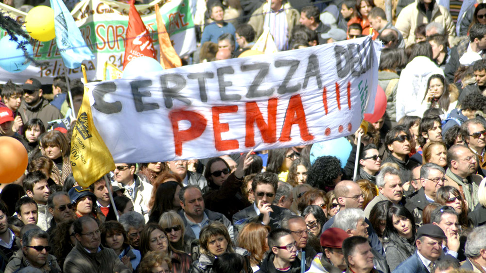 Calabrians hold banners and flags decrying organised crime during a 'Giornata della Memoria' [Adriana Sapone/AP]