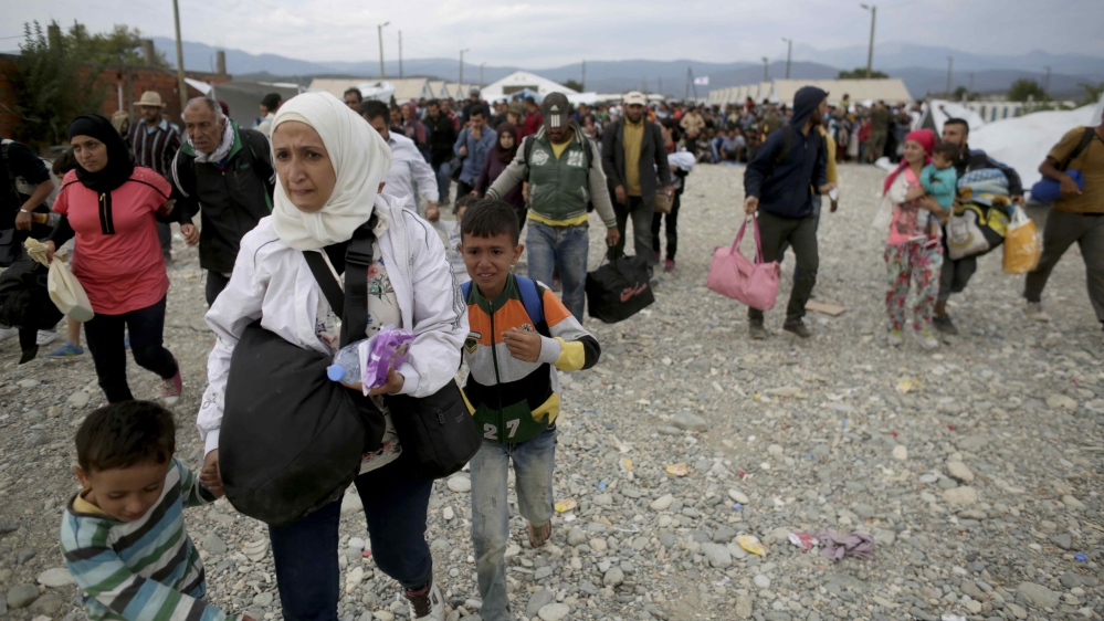 Several thousand refugees in Macedonia boarded trains on Sunday to travel north after spending a night in a provisional camp [Reuters]