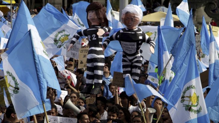 File photo of demonstrators waving Guatemalan national flags and holding effigies representing Guatemala''s President Perez Molina and former Vice President Baldetti, during a prot
