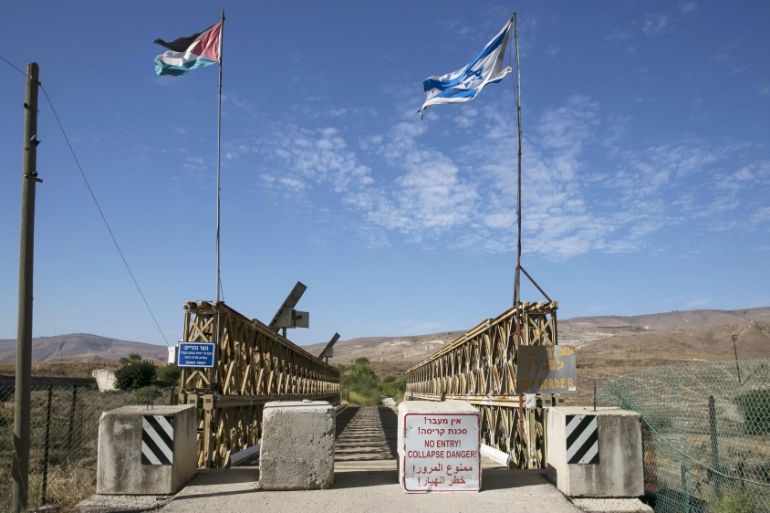 National Jordanian and Israeli flags are seen on the Naharayim bridge on the border between Israel and Jordan north-eastern Israel