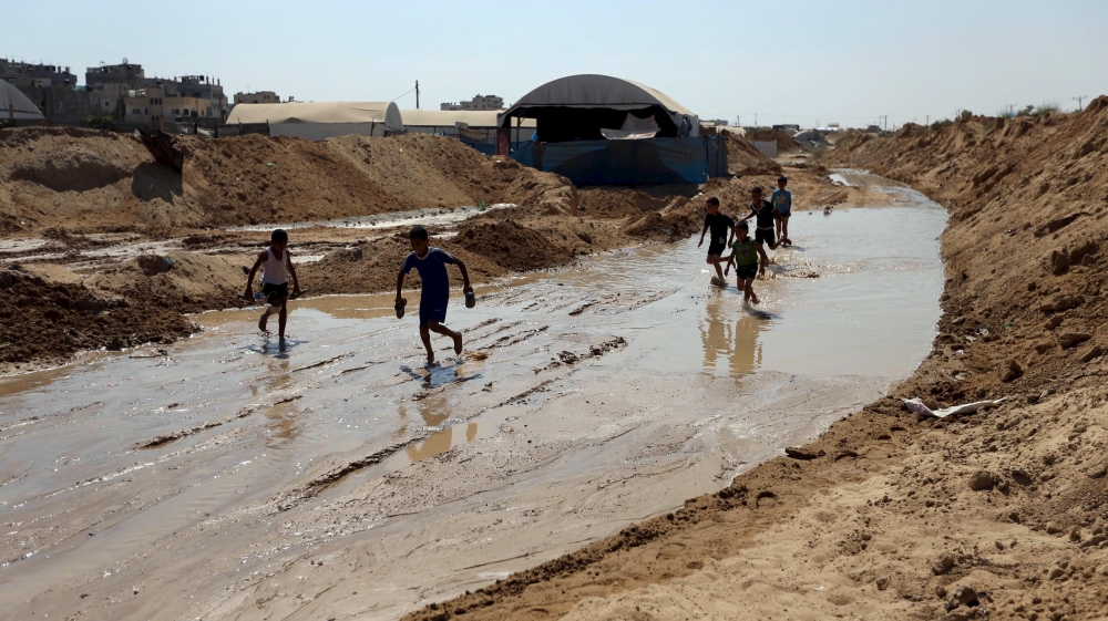 Palestinian children played in water after Egyptian forces flooded the tunnels dug beneath the Gaza-Egypt border [Reuters]