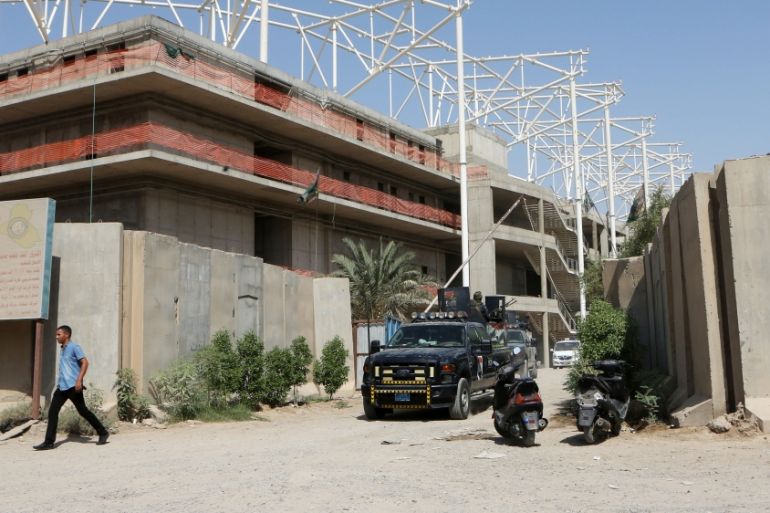 Iraqi security forces guard the entrance to a sports complex