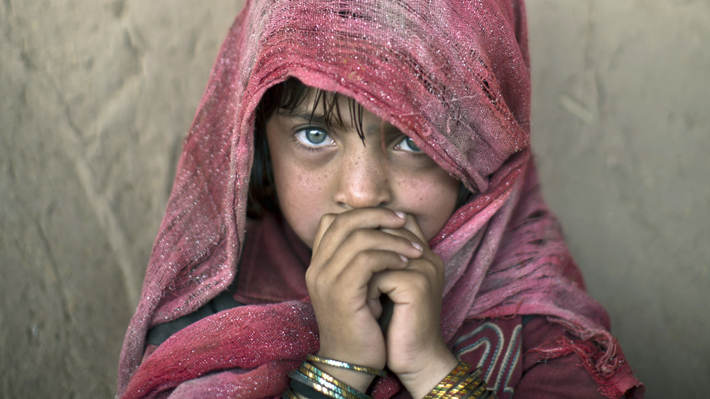 Afghan refugee Hamagai Akbar, 5, is one of thousands fleeing the country each year [Muhammed Muheisen/AP]