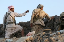 Militant and a soldier loyal to Yemen''s exiled government stand in an area where they are fighting against the Houthi militia in Yemen''s central province of Marib
