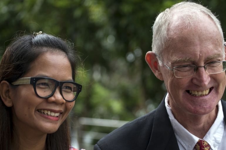 Australian journalist Alan Morison and Thai journalist Chutima Sidasathian smile as they arrive at court in Phuket, Thailand