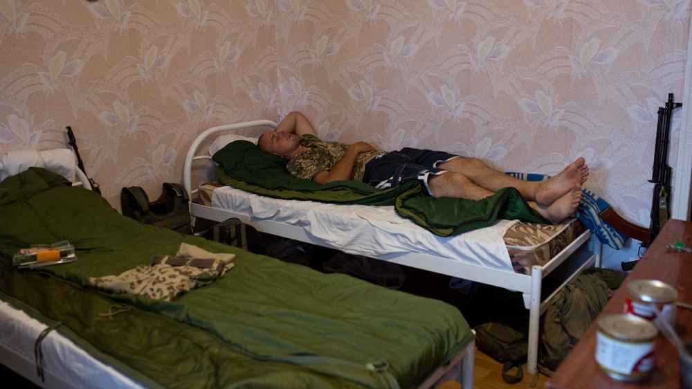 Zinc, one of Linsa's comrades, is sleeping after coming back to the rear base in Mariupol [Virginie NGUYEN HOANG] 