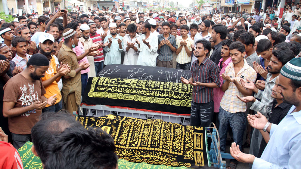Thousands gathered to offer funeral prayers for the victims of the September 12, 2012 fire [Rehan Khan/EPA]