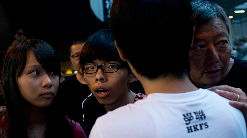 Wong is easily recognised in Hong Kong, and regularly stops to take selfies with supporters [Miguel Candela/Al Jazeera]