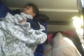 Refugee child sleeps in carriage of a train at Bicske railway station