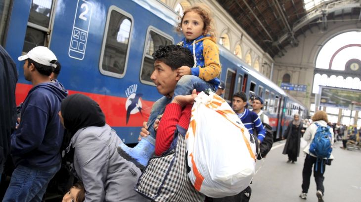 Migrants prepares to board a train heading to Hegyeshalom, at Keleti station in Budapes
