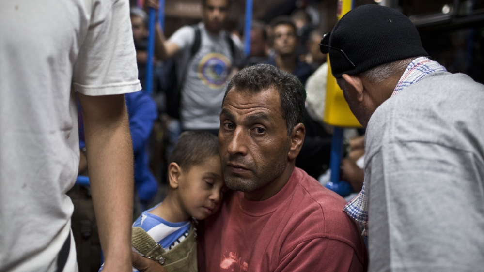 The Hungarian government deployed buses to ferry refugees to the Austrian border [AP]