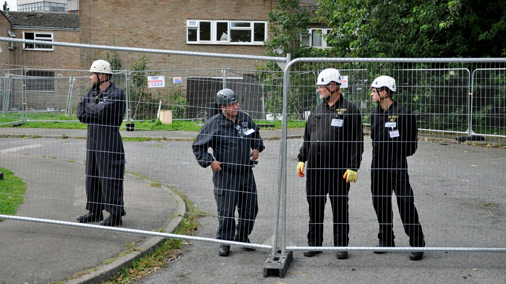 Bailiffs watched by police and emergency services moved onto the estate to remove dozens of activists and squatters on Thursday [Simon Hooper/Al Jazeera]
