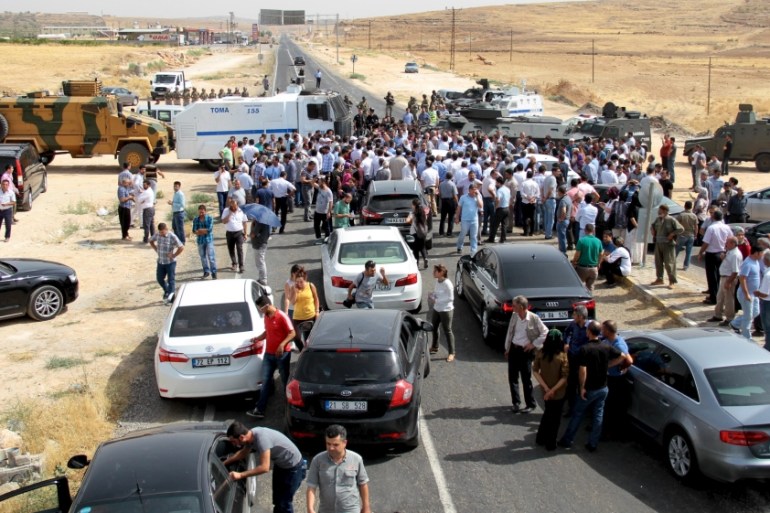 Turkish security forces block a road to stop a convoy, carrying a delegation of the pro-Kurdish Peoples'' Democratic Party (HDP), near the southeastern town of Midyat