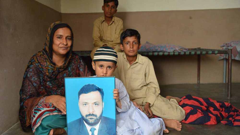 Shahida Parveen with her sons: Muhammad Hamza, 11, Ameen Akmal, 8, and Ahmed Akmal, 3 [Amar Guriro/Al Jazeera]