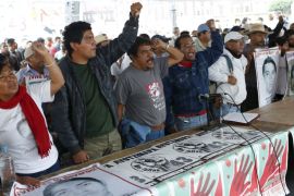 Relatives hold pictures of some of the 43 missing students of Ayotzinapa College Raul Isidro Burgos and shout during a news conference after a private meeting with Mexico''s President Enrique Pena Niet