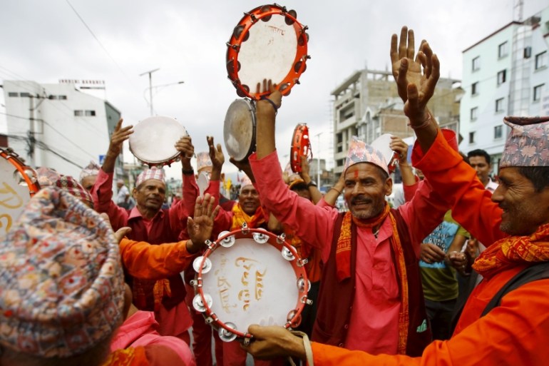 Hindu activists sing and dance as they take part in a protest rally demanding Nepal to be declared as a Hindu state in the new constitution, in Kathmandu