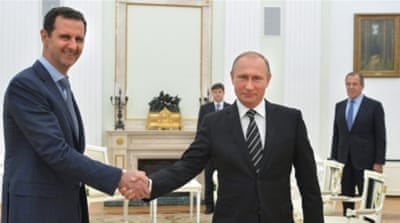 Russian President Vladimir Putin shakes hands with Syrian President Bashar al-Assad [AP]