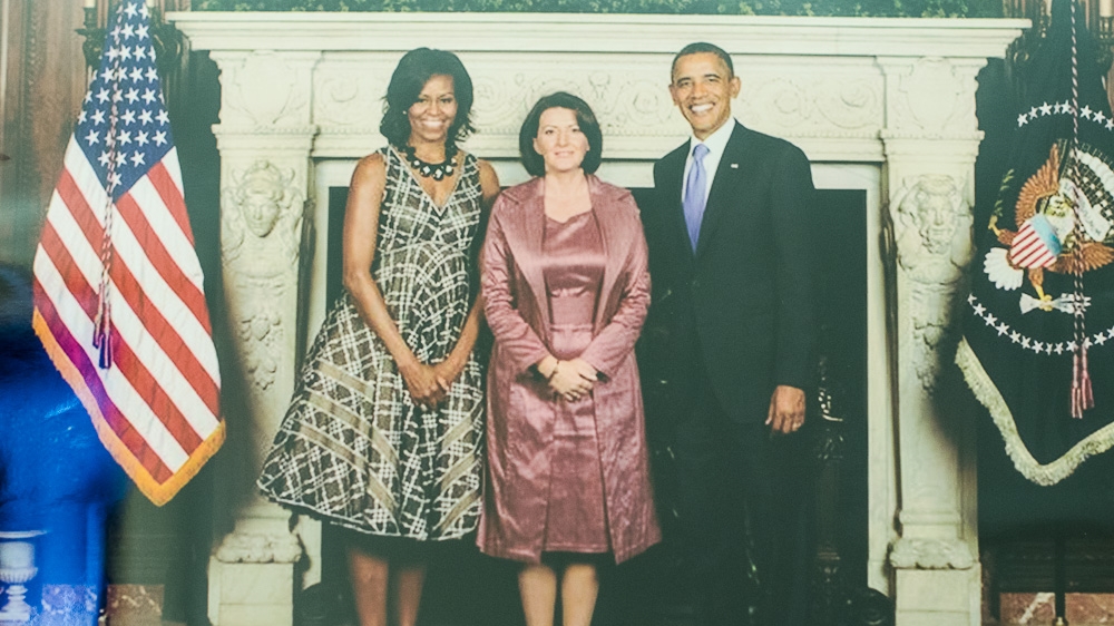 A photograph of President Jahjaga with US President Barack Obama and First Lady Michelle Obama taken in September 2011 in New York City hangs on the wall of the president's cabinet [Valerie Plesch/Al Jazeera]