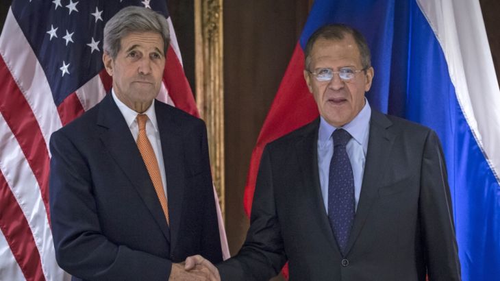 U.S. Secretary of State John Kerry and Russian Foreign Minister Sergey Lavrov shake hands during a photo a photo opportunity in Vienna