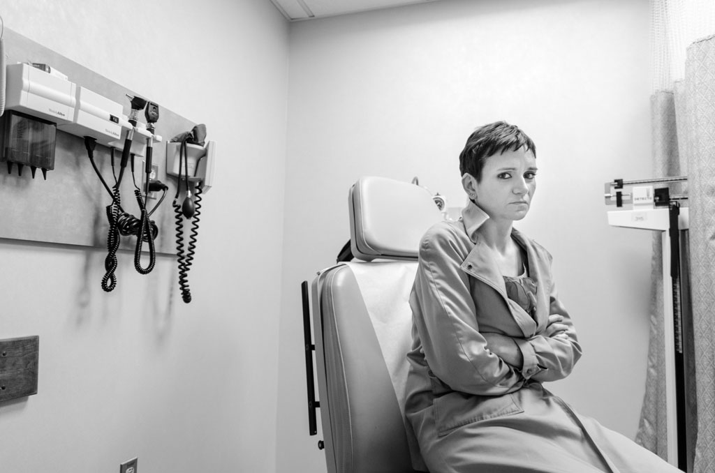 Jennifer, nervous and anxious, waits to meet with a radiologist to discuss possible treatment options for her cancer. Jen's cancer metastasized to her liver and bone a year-and-a-half after she finished her treatment for breast cancer. [Angelo Merendino/Al Jazeera] 