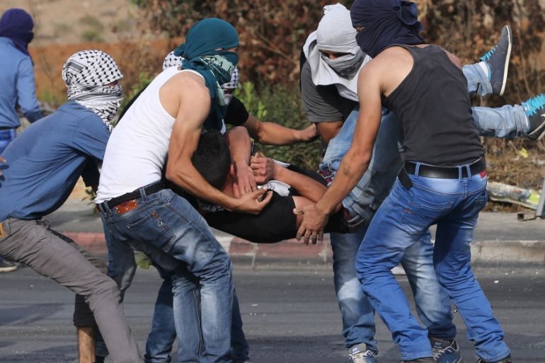 Wounded Palestinian protester is evacuated during clashes with the Israeli troops near the Jewish settlement of Bet El, near the West Bank city of Ramallah