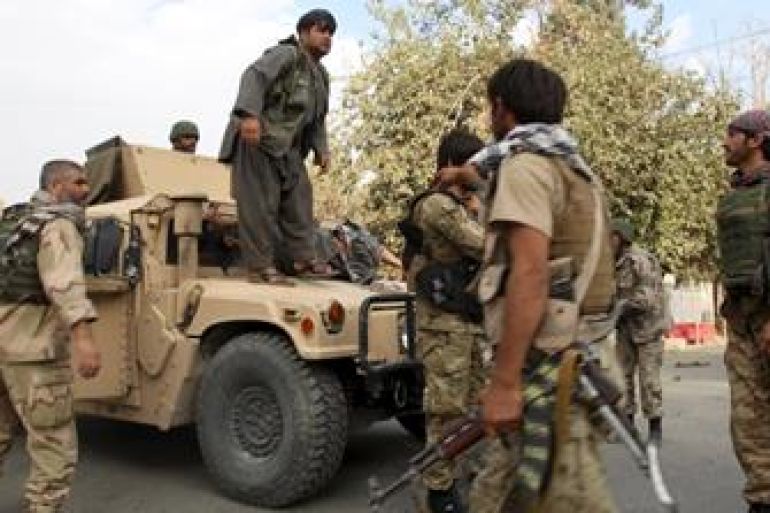 Afghan security forces prepare to transport an injured civilian after a battle with the Taliban in the city of Kunduz