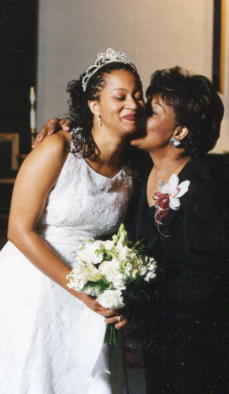 The bride is kissed by her mother after walking down the aisle [Courtesy of Jacinda Townsend] 