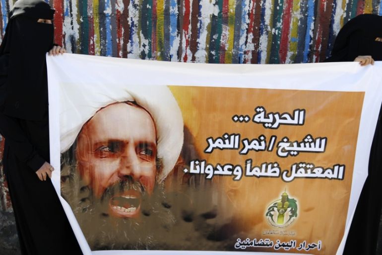 Shi''ite protesters carry a poster of Sheikh Nimr al-Nimr during a demonstration outside the Saudi embassy in Sanaa