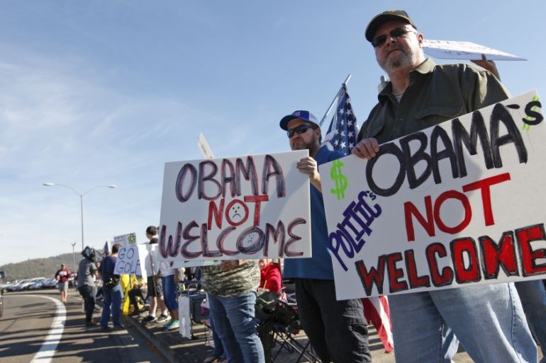People protest the visit by US President Obama to their town of Roseburg, Oregon