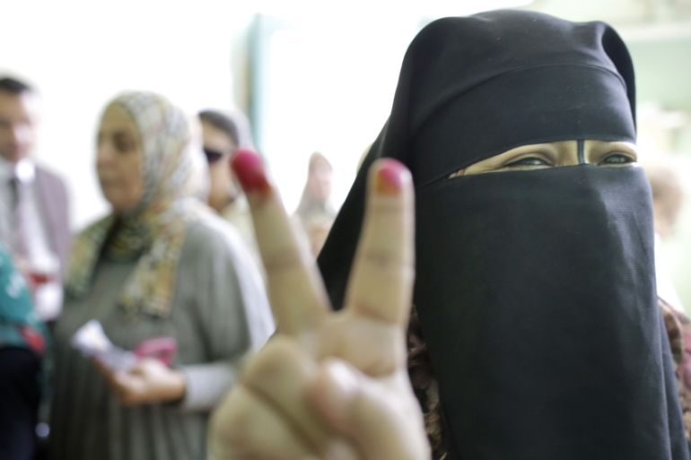 An Egyptian voter gestures
